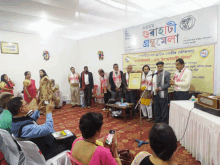 a group of people are gathered in front of a sign that says ' bangladeshi '