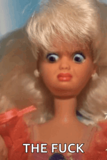 a close up of a barbie doll with the words the fuck written on the bottom