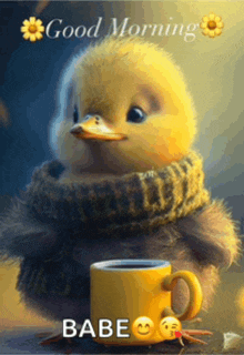 a duck with a scarf around its neck is next to a cup of coffee