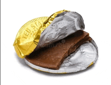 a piece of chocolate is sitting on top of a gold and silver foil wrapper .