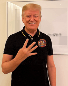 a man wearing a black shirt with a patch that says lotto
