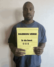 a man is holding a piece of paper that says daemon verse