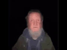 a blurry picture of a man with a beard and red face .