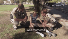 a police officer kneeling down next to a man with the words i was murdered