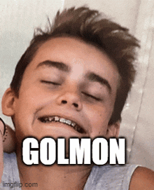 a young boy with braces on his teeth is smiling with the name golmon on his face