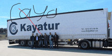 a group of men standing in front of a truck that says kayatur on it