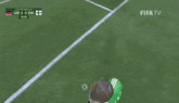 a soccer goalie stands in front of a wall that says fifa
