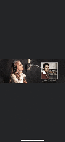 a woman singing into a microphone with a picture of elvis presley