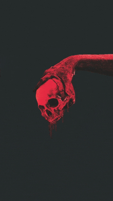 a hand is holding a bloody skull with blood dripping from it