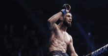 a man in a boxing ring with a sign that says ufc on it