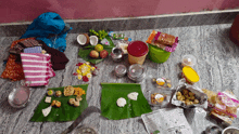 a bunch of food on a table with a newspaper on the floor that says ' chennai ' on it