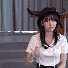 a woman wearing a helmet with horns and goggles on her head