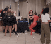 a group of people are dancing in a room with the word zeus on the bottom right