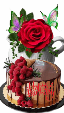 a birthday cake with raspberries and a red rose on top