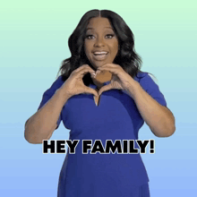 a woman in a blue dress making a heart with her hands and the words hey family