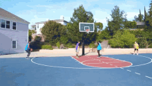 a group of people are playing basketball on a court with a basketball hoop that has the letter g on it