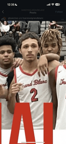 a group of basketball players are posing for a picture and one has the number 2 on his jersey