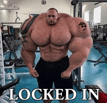 a very muscular man with a tattoo on his arm is locked in a gym .