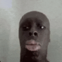 a close up of a black man 's face with a white spot on his face .