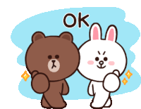 a brown bear and a white rabbit are standing next to each other with the word ok above them .