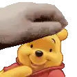 a winnie the pooh bear with a towel on his head .