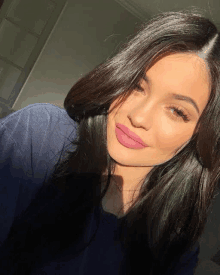 a close up of a woman taking a selfie with a pink lip .