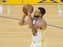 golden state warriors basketball player stephen curry is shooting a basketball during a game against the houston rockets .