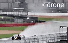 a drone is flying over a race car on the track