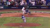 a baseball game is being played in front of a capital one sign