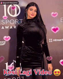 a woman in a black dress is standing in front of a 10 sport award poster