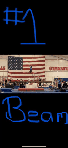 a gymnast is doing a trick on a balance beam in a gym with an american flag in the background .