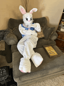 a stuffed bunny is sitting in a chair next to a tray with a picture of a butterfly on it