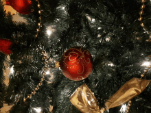 a christmas tree with red and gold ornaments