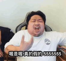 a man in a white shirt with chinese writing on it is making a funny face