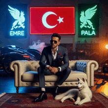 a man in a suit sits on a couch with a husky dog in front of a neon sign that says emre and pala