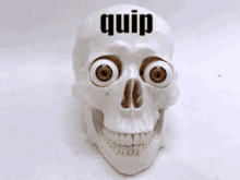 a skull with big red eyes and the word quip on it .