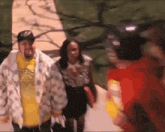 a man in a yellow shirt is walking with a woman in a white jacket