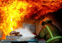 a fireman is spraying water on a fire while wearing a helmet