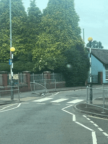 a street with a fence and a sign that says ' ambulance ' on it