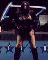 a woman is dancing in front of a sign that has the letter a on it