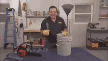 a man holding a knife next to a bucket with the word flying kitty written on it