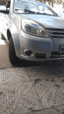 a silver car with a license plate that reads nm