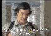 a man with a name tag that says ' my best friend is black im not racist '