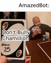 a man is holding a card that says `` do n't bully chamillion '' while playing uno .