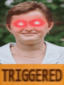 a picture of a woman with red eyes and the word triggered below her