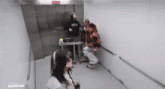 a man and a woman are standing in a hallway with a sign that says cma air