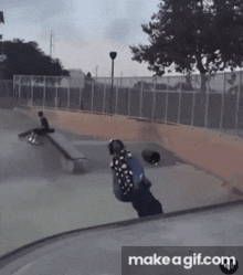 a skateboarder is doing a trick at a skate park with the words make a gif.com below him