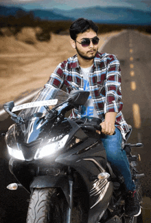 a man wearing sunglasses is riding a motorcycle with a license plate that says ' srk l ' on it