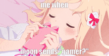 a girl laying on a bed holding a pink phone with the words " me when moon sends gamer "