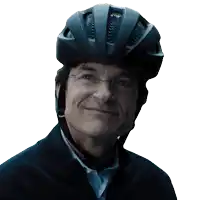 a man wearing a bicycle helmet and glasses smiles for the camera
